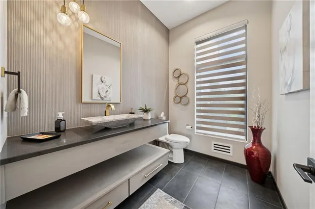 a bathroom with a double vanity sink toilet and shower