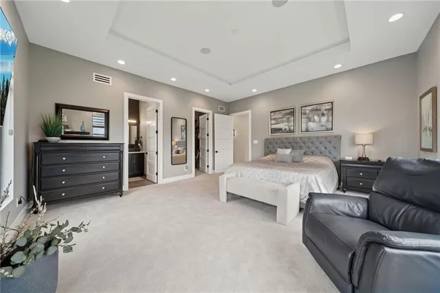 a spacious bedroom with a bed and furniture