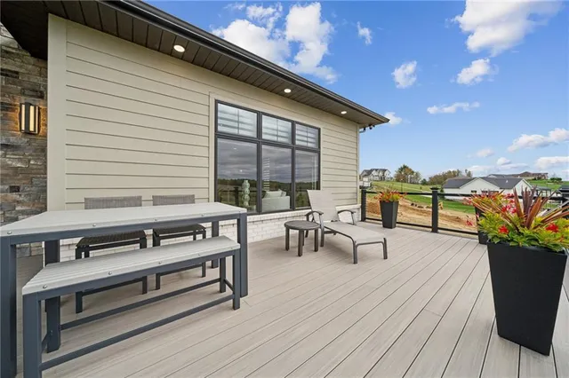 a roof deck with a table and chairs
