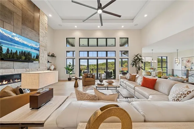 a living room with fireplace furniture and a large window