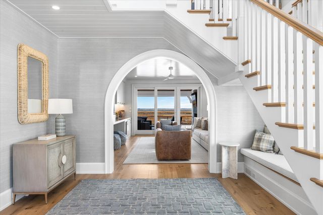 a view of a livingroom with furniture staircase and kitchen view