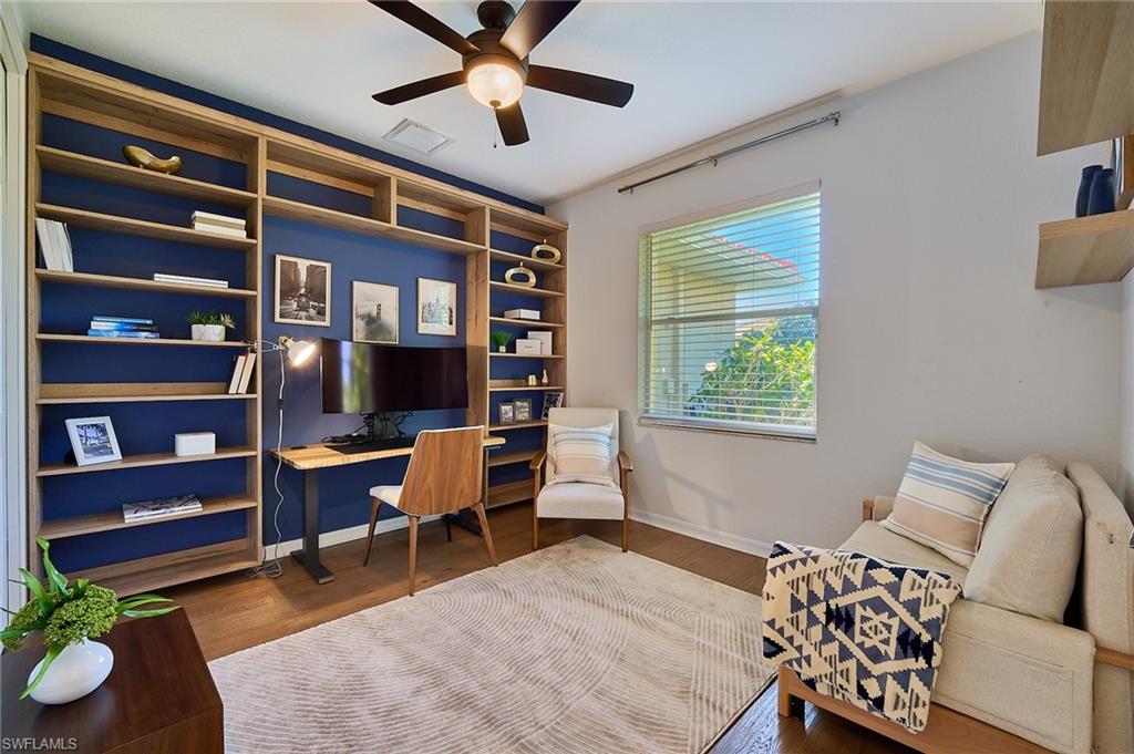 186 Muirfield Circle Naples, FL 34113 - Photo 22 of 36 a bedroom with a bed and a bookshelf