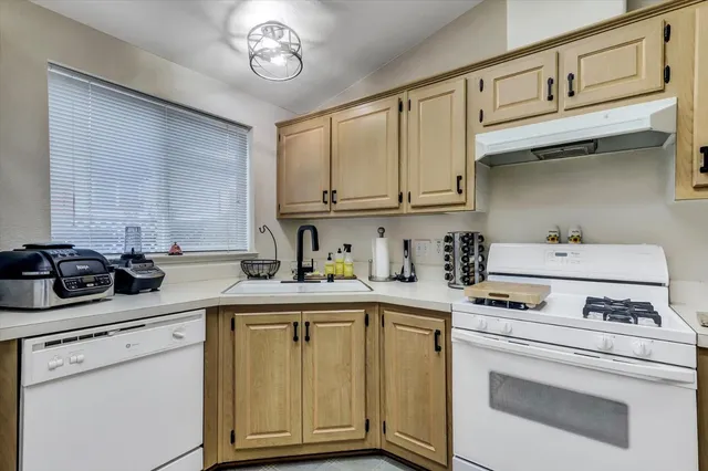 a kitchen with appliances cabinets and a sink