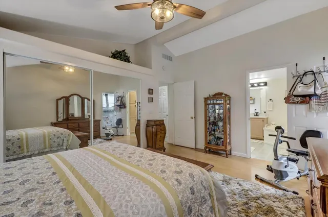 a bedroom with bed and a chandelier