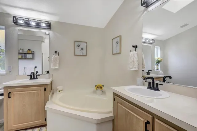 a bathroom with a sink a toilet a mirror and shower