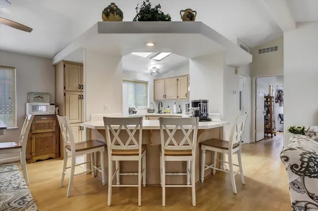 a dining room with furniture and wooden floor
