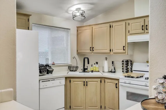 a kitchen with stainless steel appliances a sink stove and cabinets