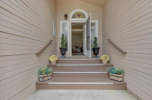 a front view of a house with a potted plant