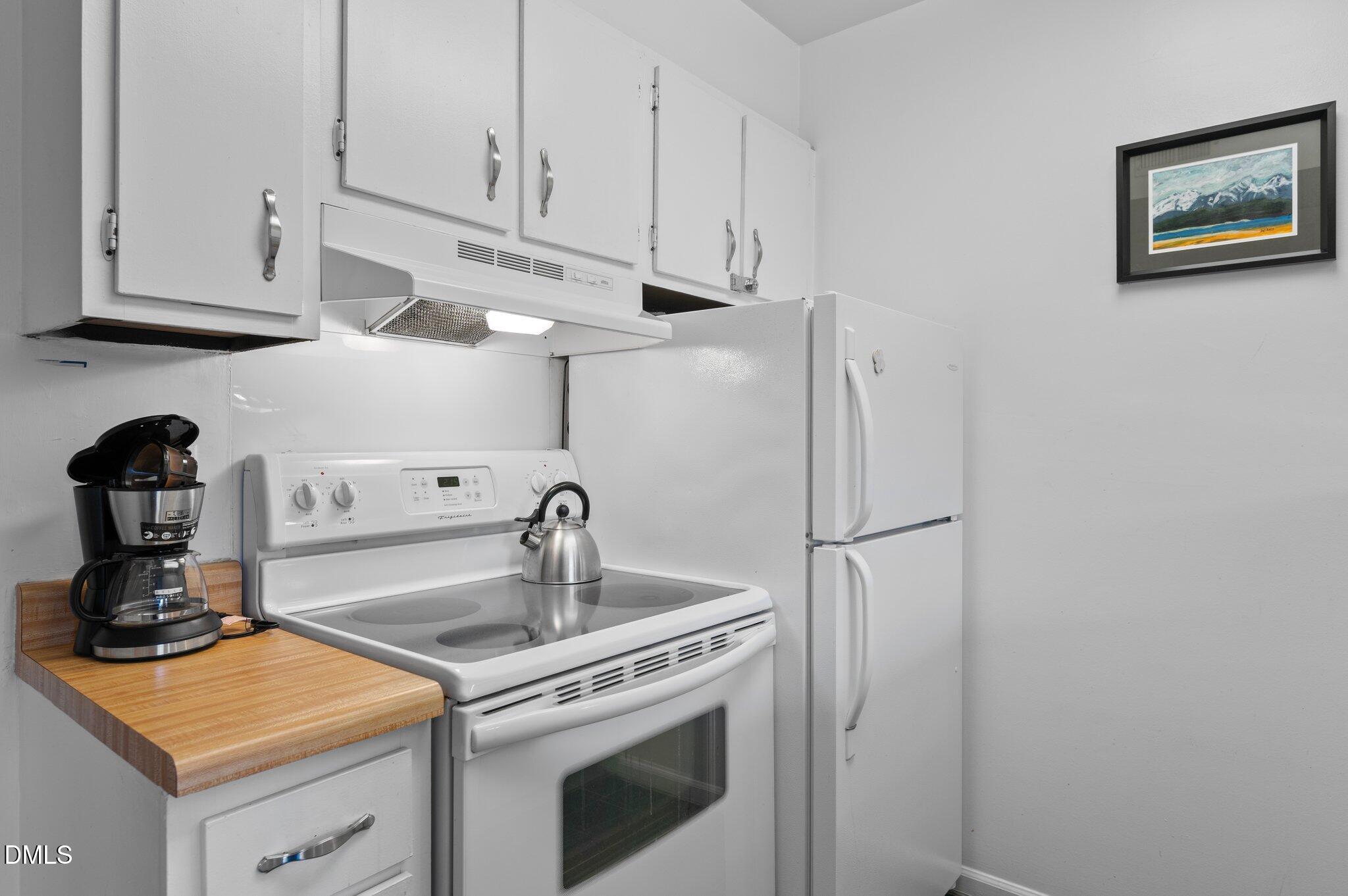 807 West Trinity Avenue, Unit 153 Durham, NC 27701 - Photo 11 of 39 a kitchen with stainless steel appliances granite countertop a sink and a stove