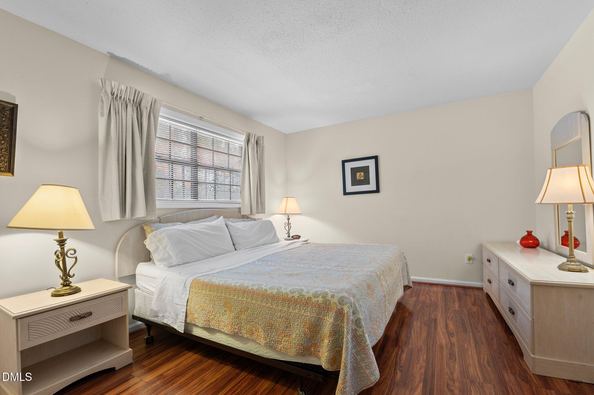 807 West Trinity Avenue, Unit 153 Durham, NC 27701 - Photo 13 of 39 a bedroom with a bed and a lamp