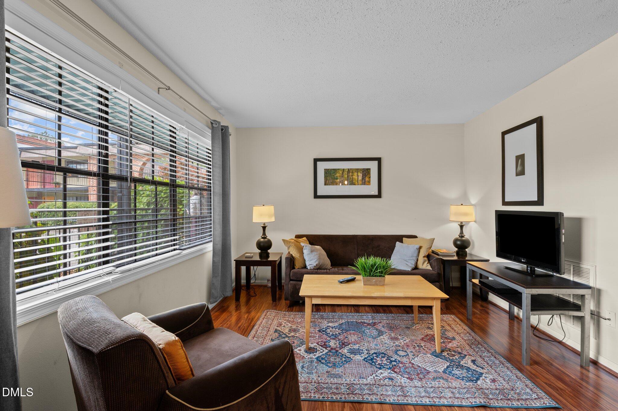807 West Trinity Avenue, Unit 153 Durham, NC 27701 - Photo 2 of 39 a living room with furniture and a flat screen tv