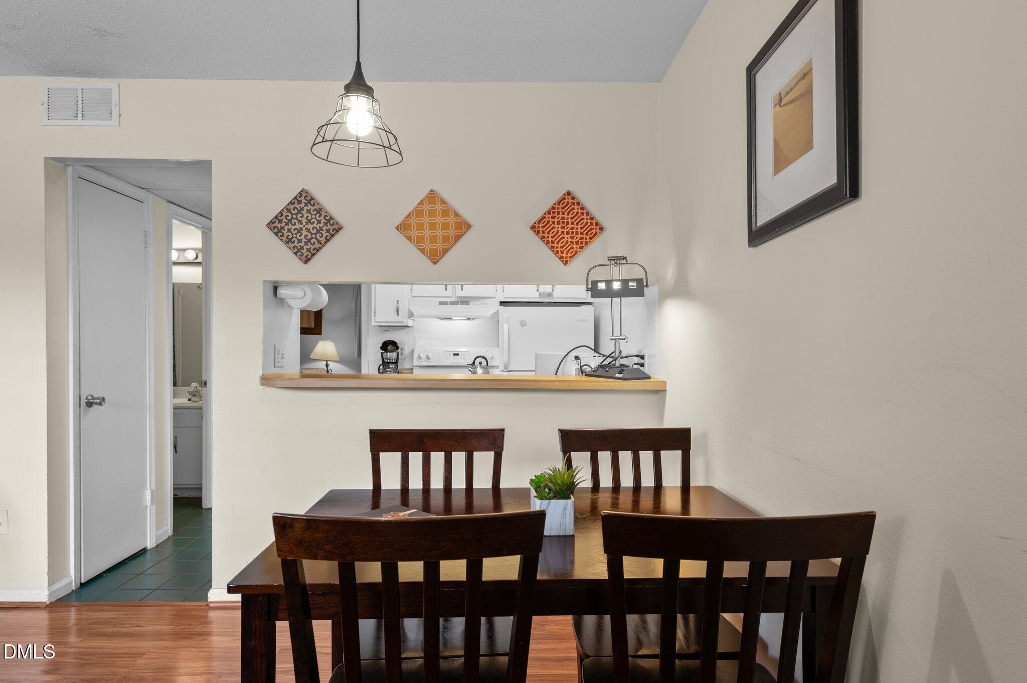 807 West Trinity Avenue, Unit 153 Durham, NC 27701 - Photo 4 of 39 a view of a dining room with furniture window and wooden floor