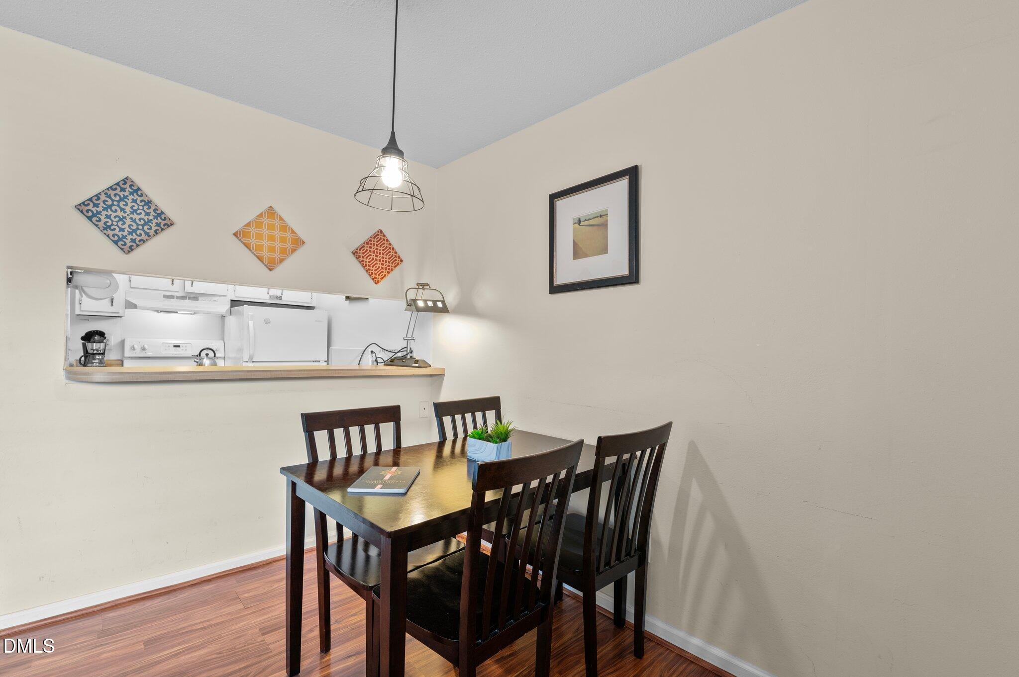 807 West Trinity Avenue, Unit 153 Durham, NC 27701 - Photo 5 of 39 a view of a dining room with furniture and wooden floor