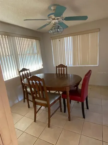 a view of a dining room with furniture and window