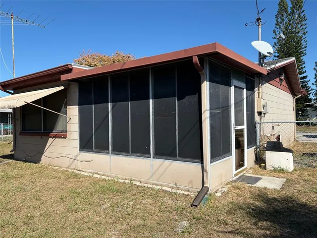 a backyard of a house with palm tree