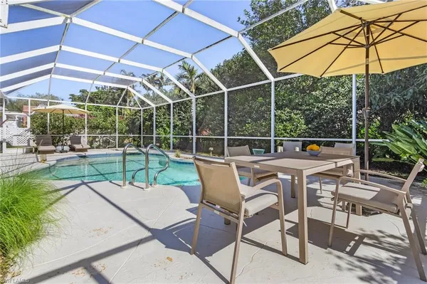 a view of a chairs and table in the patio