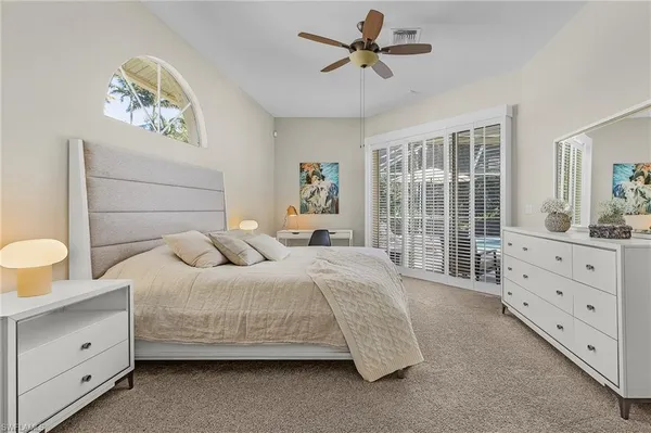 a bedroom with a large bed and a window
