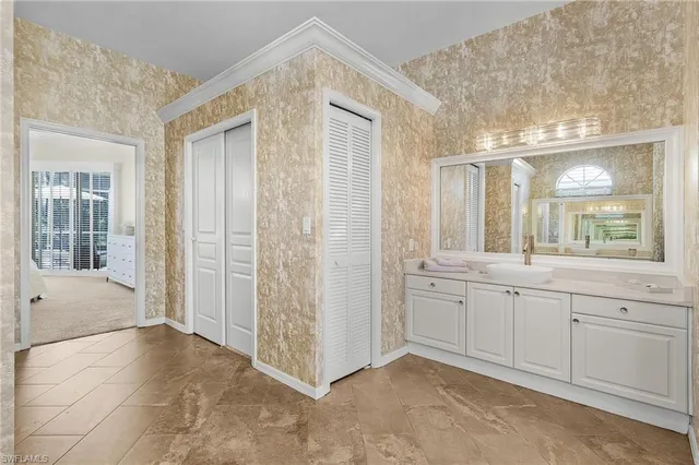 a spacious bathroom with a granite countertop sink mirror and a