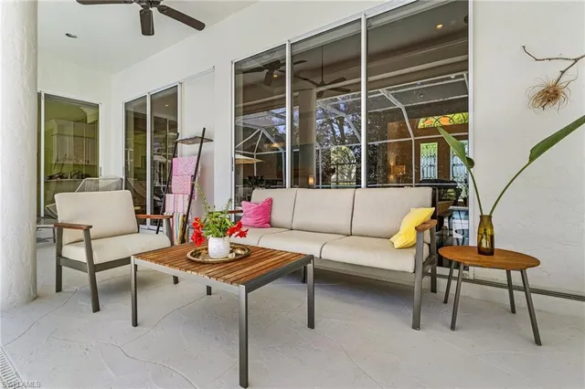 a living room with furniture a window and a flat screen tv