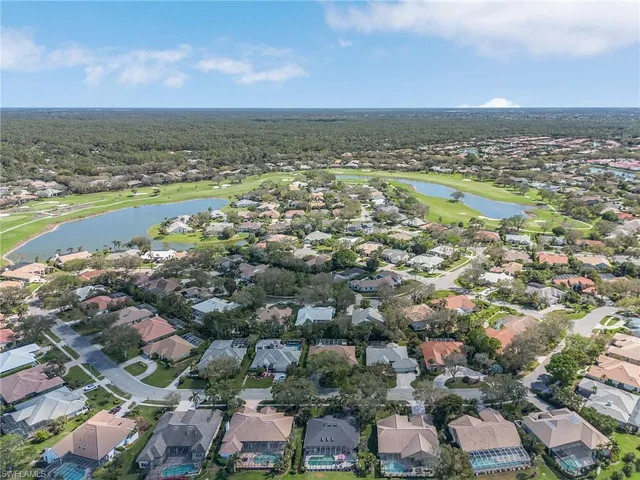 an aerial view of residential building and lake