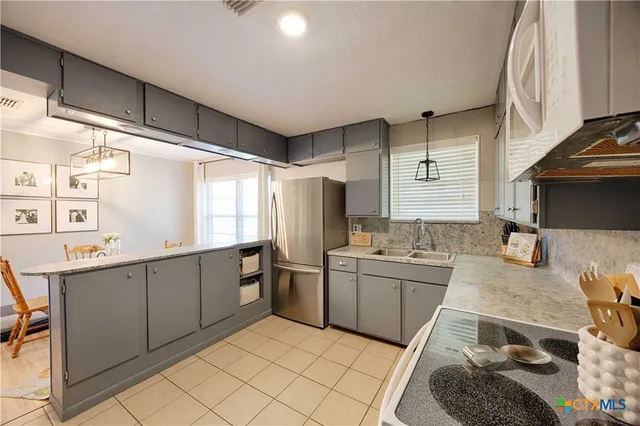 a kitchen with sink cabinets and stove
