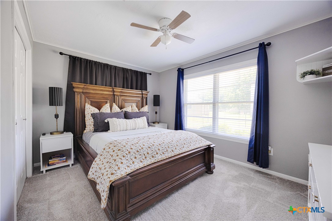 207 River Street Hallettsville, TX 77964 - Photo 16 of 25 a bed sitting in a bedroom next to a window