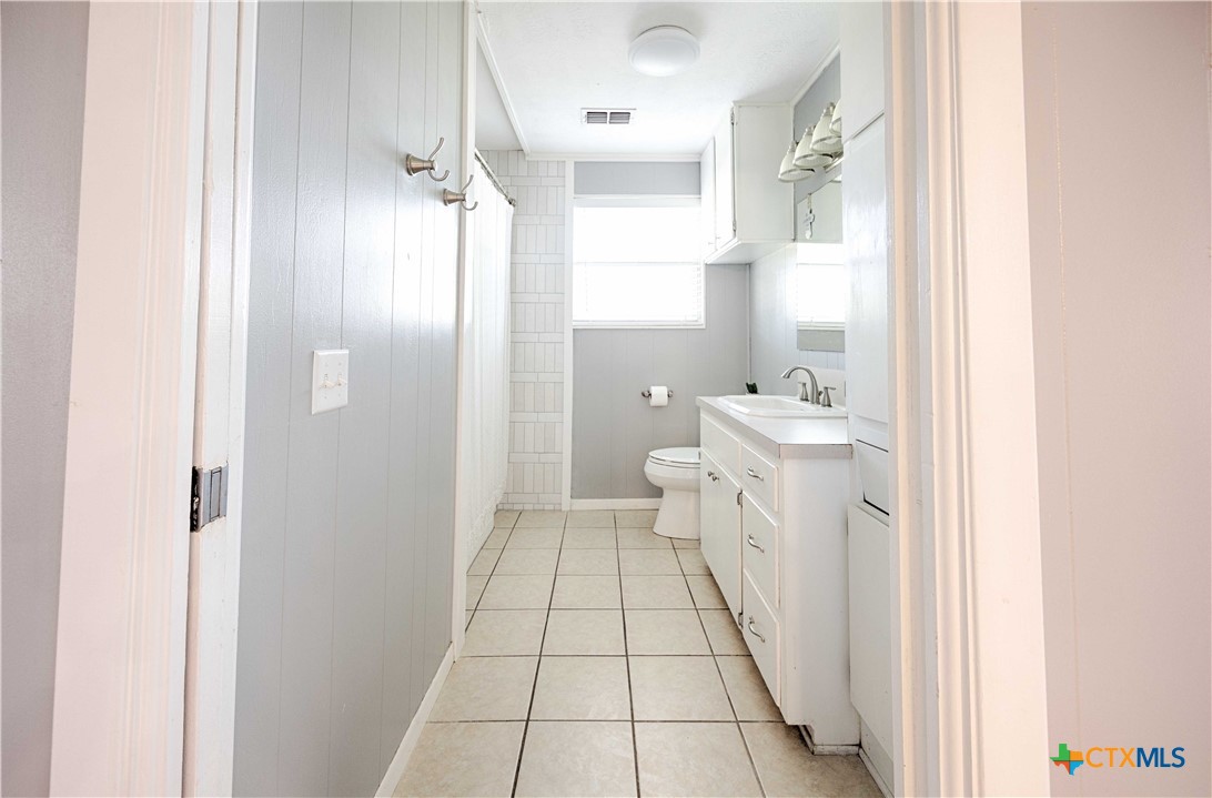 207 River Street Hallettsville, TX 77964 - Photo 18 of 25 a bathroom with a sink a toilet and shower