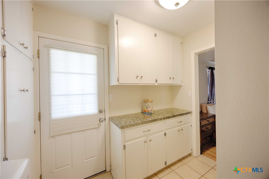 207 River Street Hallettsville, TX 77964 - Photo 20 of 25 a kitchen with a sink window and cabinets