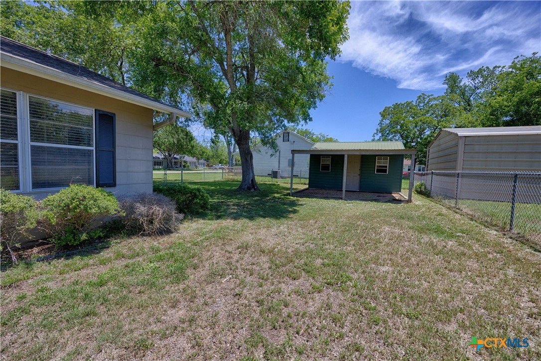 207 River Street Hallettsville, TX 77964 - Photo 24 of 25 a view of a house with backyard and a tree