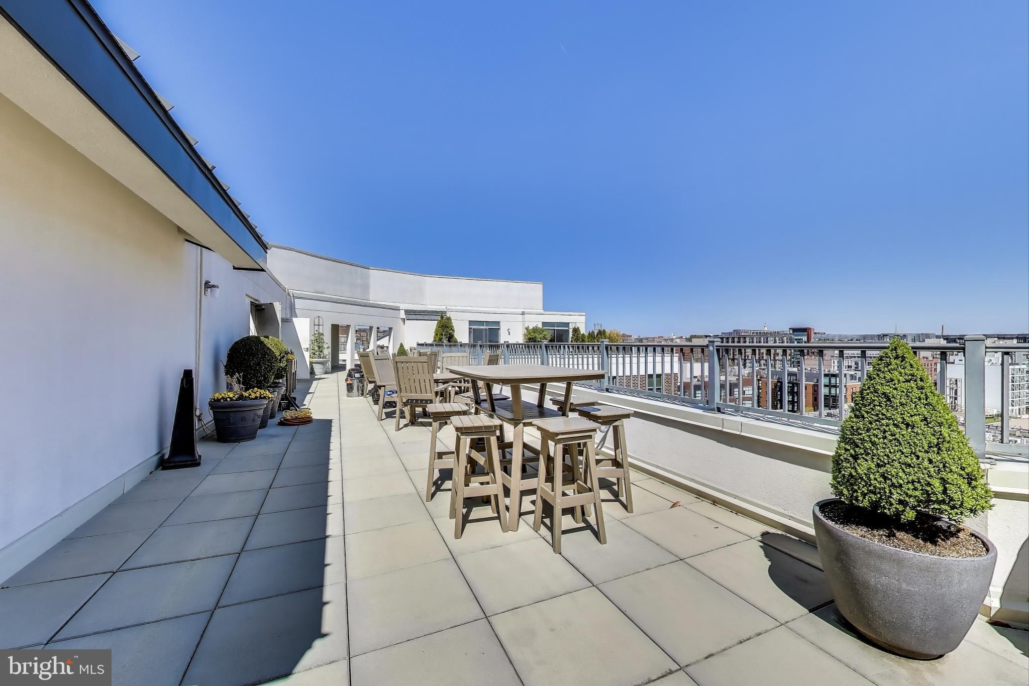 2020 12th Street Northwest, Unit 506 Washington, DC 20009 - Photo 6 of 7 a view of a terrace with furniture and potted plants