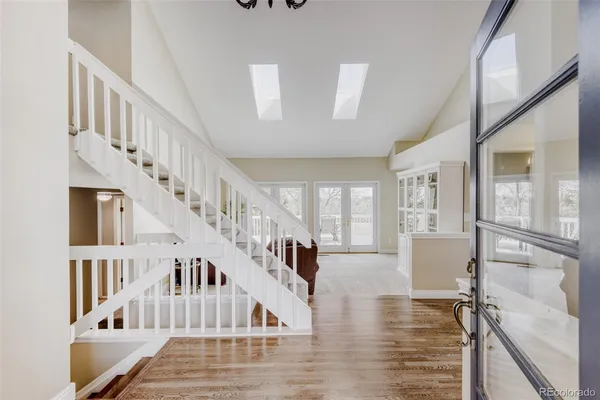 a view of entryway and hall with wooden floor