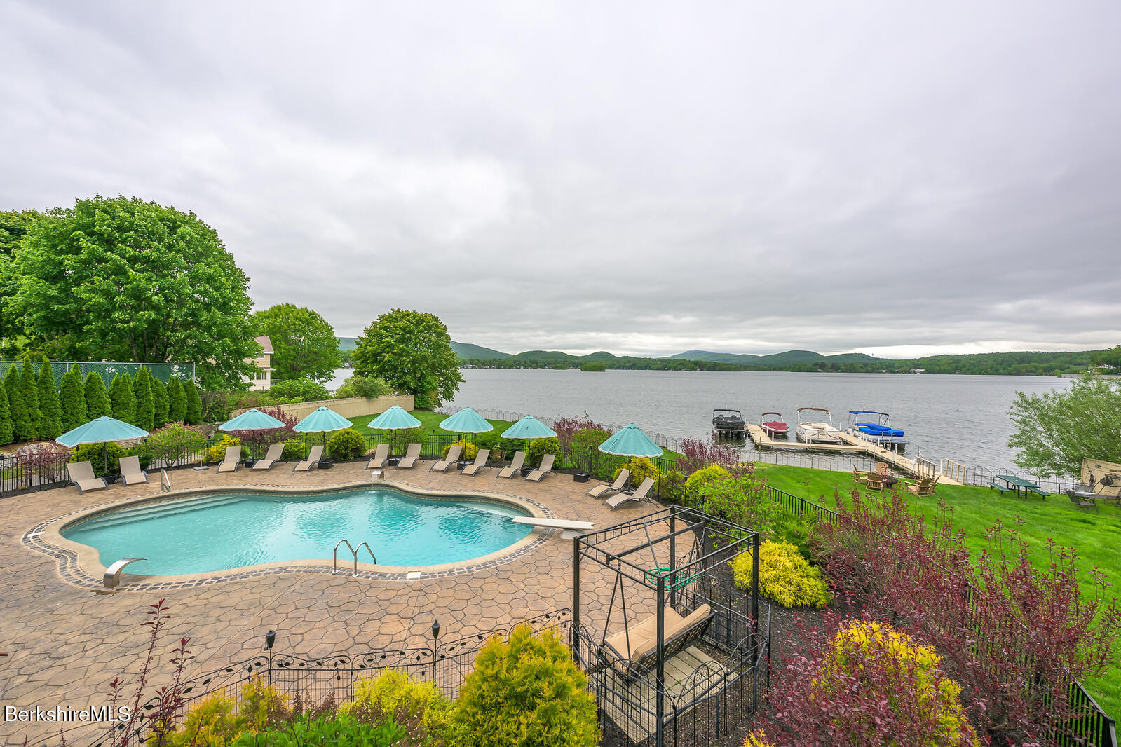 an aerial view of a house with a garden and lake view