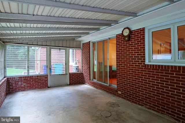 a front view of a house with a yard and potted plants