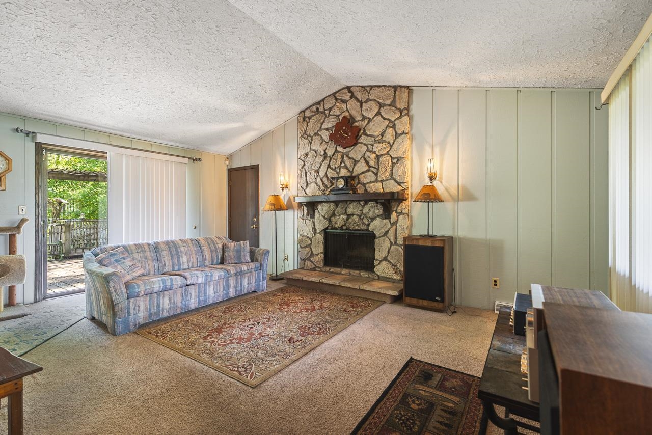 6537 Newburg Road Rockford, IL 61108 - Photo 11 of 29 a living room with furniture a flat screen tv and a fireplace