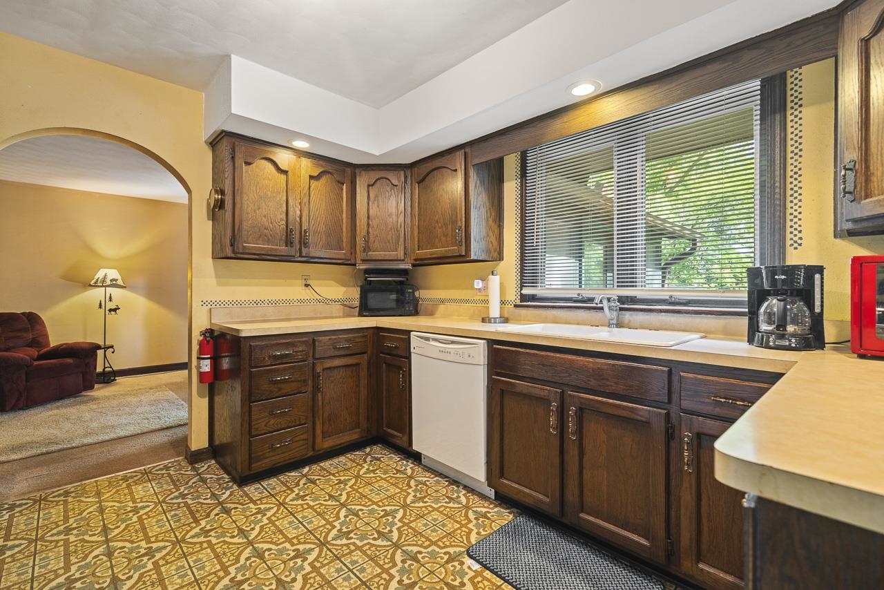 6537 Newburg Road Rockford, IL 61108 - Photo 14 of 29 a kitchen with a sink stove and cabinets