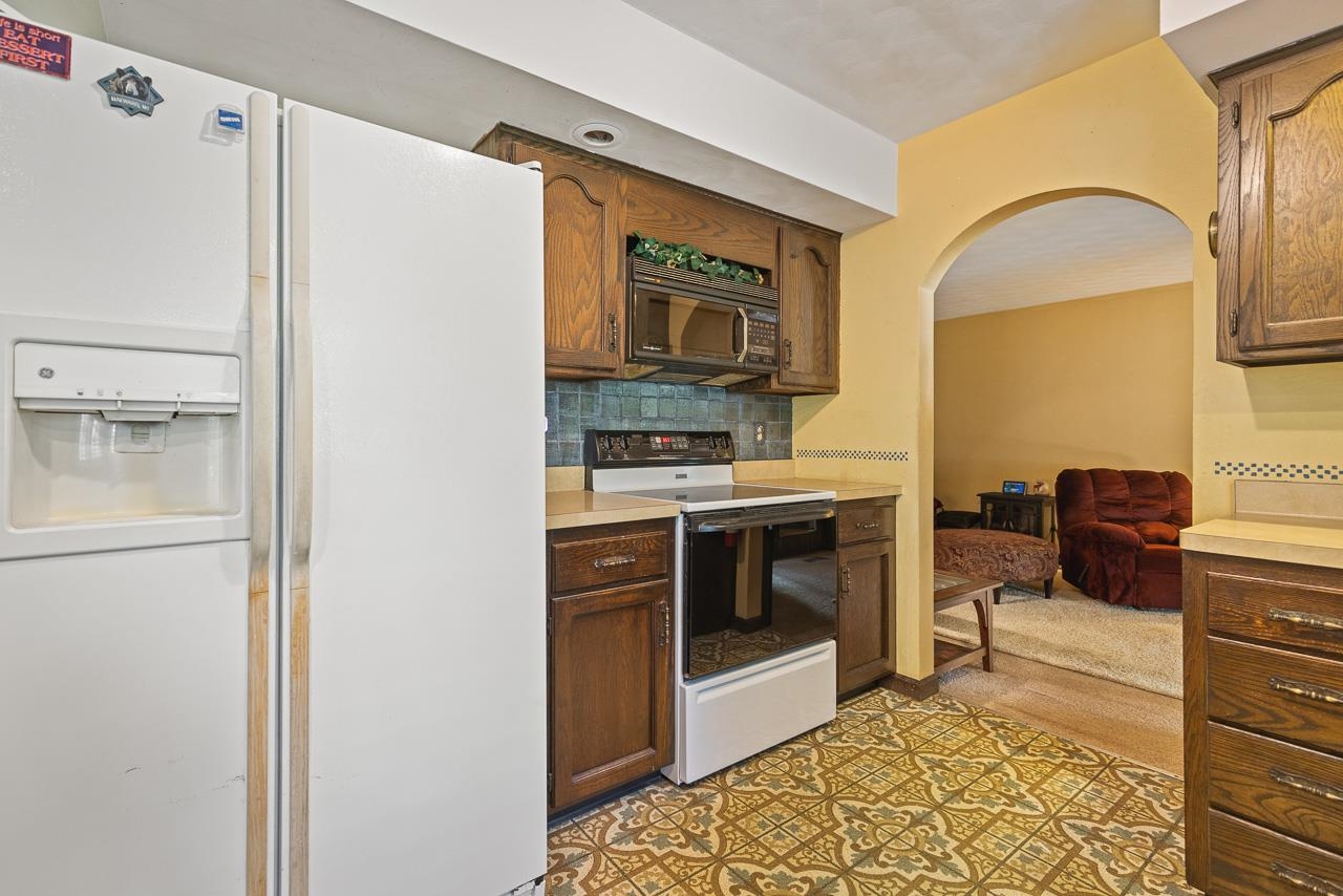 6537 Newburg Road Rockford, IL 61108 - Photo 15 of 29 a kitchen with stainless steel appliances granite countertop a refrigerator and a stove
