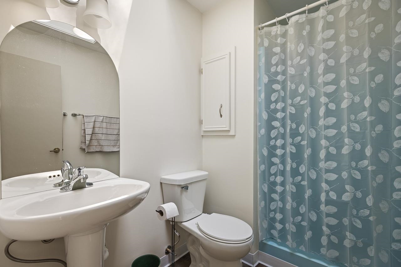 6537 Newburg Road Rockford, IL 61108 - Photo 17 of 29 a bathroom with a sink toilet and a mirror