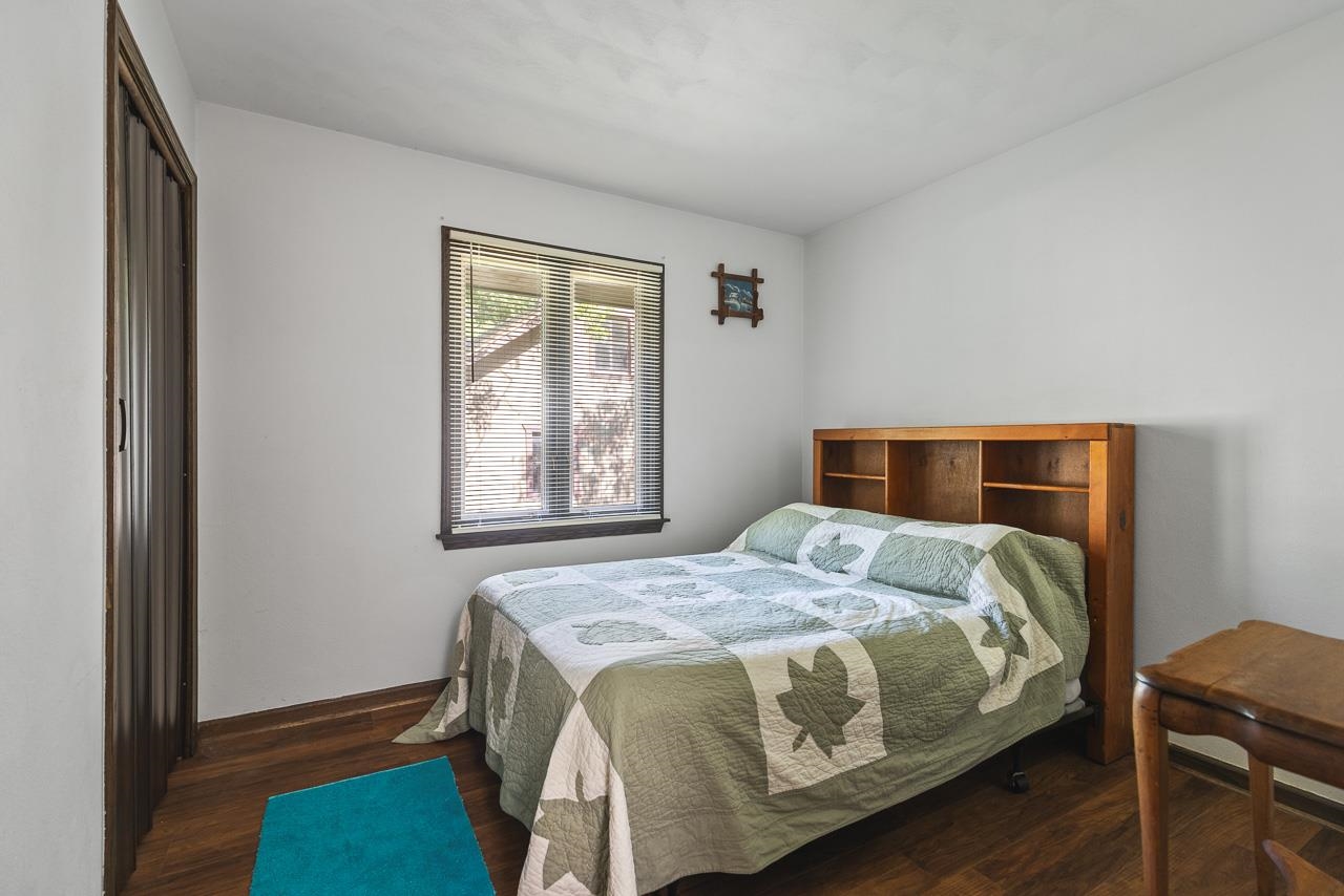 6537 Newburg Road Rockford, IL 61108 - Photo 19 of 29 a bedroom with a bed and wooden floor