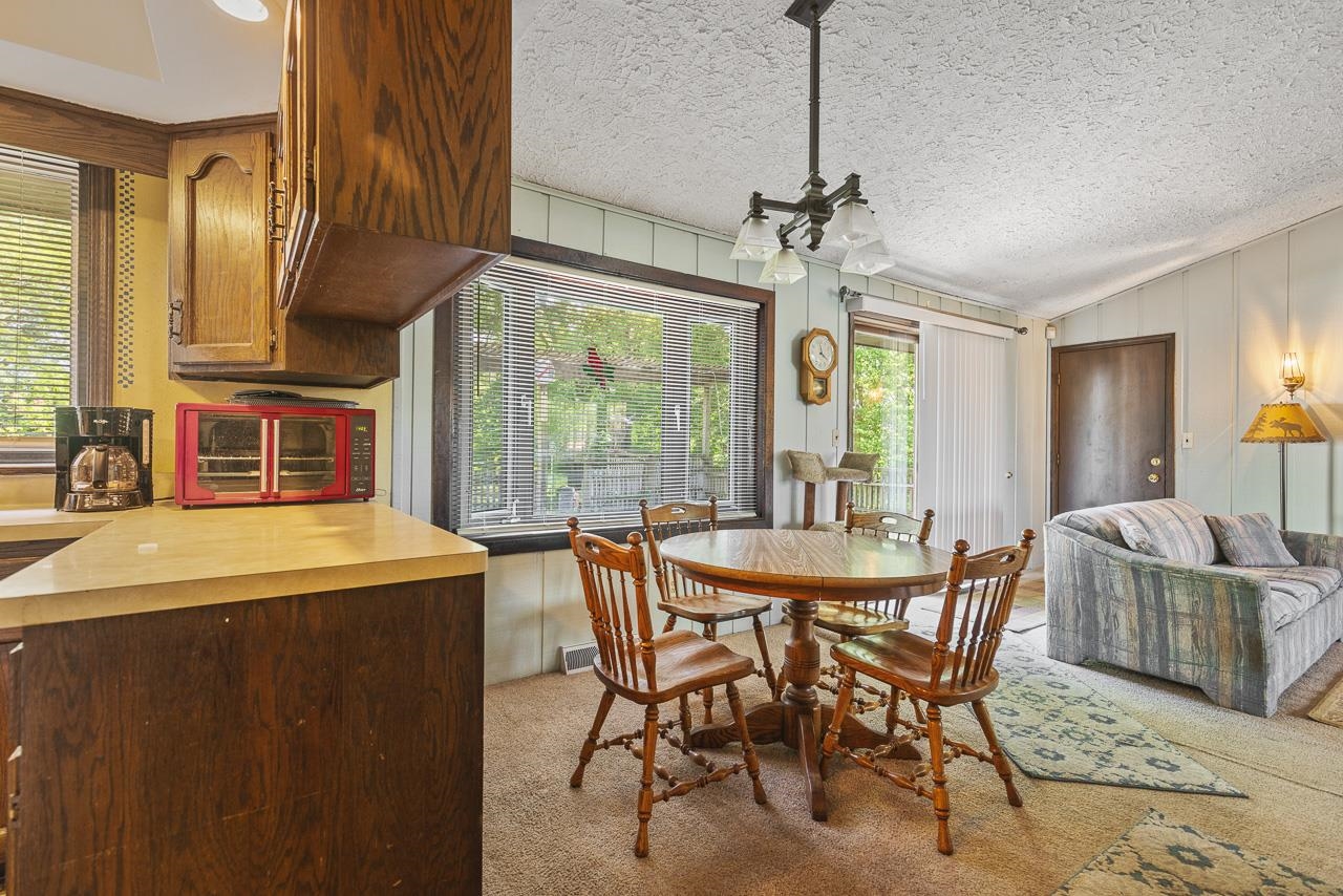 6537 Newburg Road Rockford, IL 61108 - Photo 21 of 29 a dining room with furniture a chandelier and window