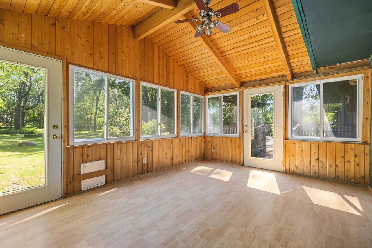 6537 Newburg Road Rockford, IL 61108 - Photo 9 of 29 an empty room with wooden floor and windows