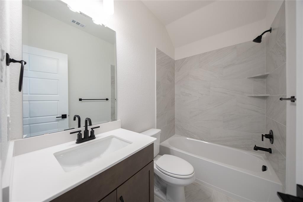 2719 Triumph Court Heath, TX 75126 - Photo 9 of 39 a bathroom with a sink a toilet and shower