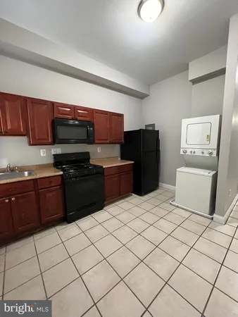 a kitchen with stainless steel appliances a sink and a refrigerator