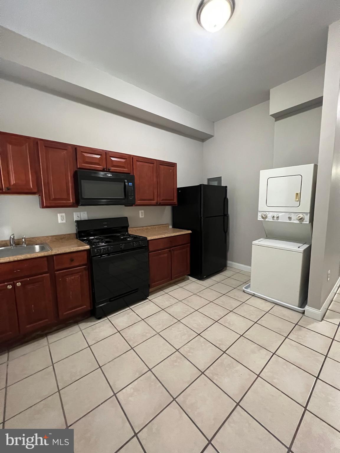 2014 McCulloh Street, Unit 1 Baltimore, MD 21217 - Photo 7 of 10 a kitchen with stainless steel appliances a sink and a refrigerator