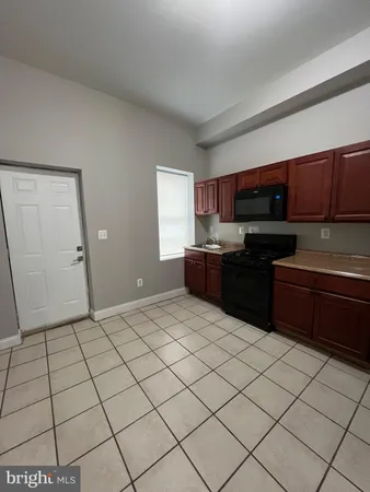 a kitchen with stainless steel appliances a sink and a microwave