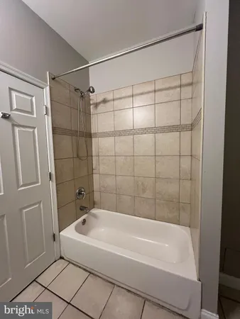 a bathroom with a shower and a bath tub