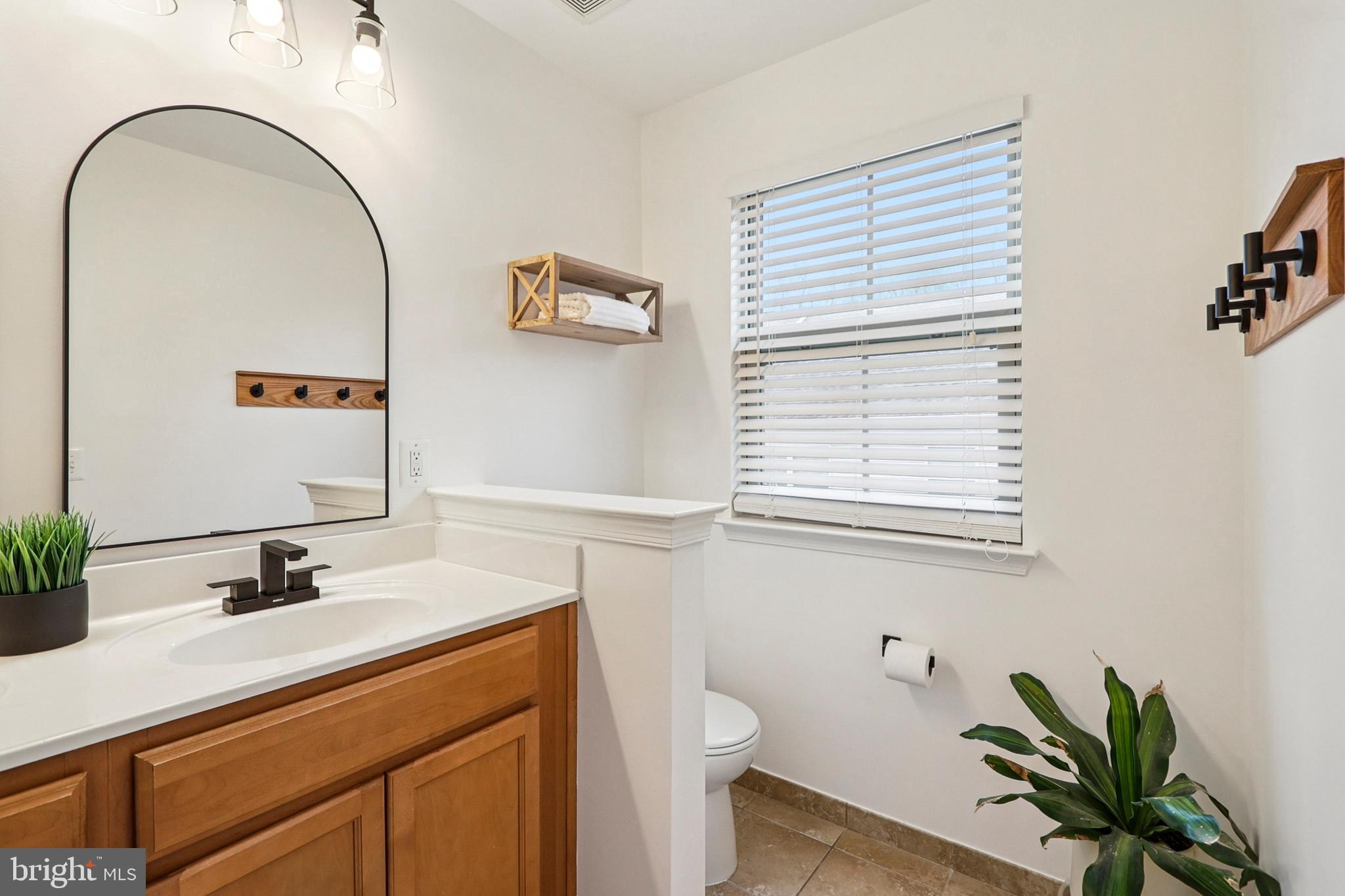 4505 Potomac Highlands Circle Triangle, VA 22172 - Photo 43 of 65 a bathroom with a sink a mirror and a toilet