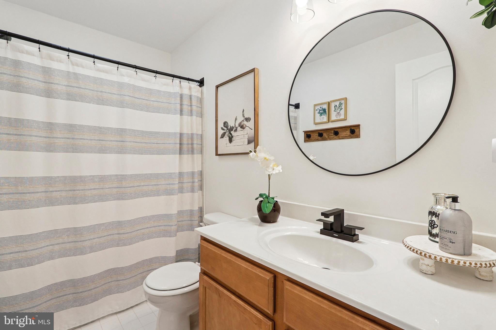 4505 Potomac Highlands Circle Triangle, VA 22172 - Photo 47 of 65 a bathroom with a sink a mirror a toilet and a mirror