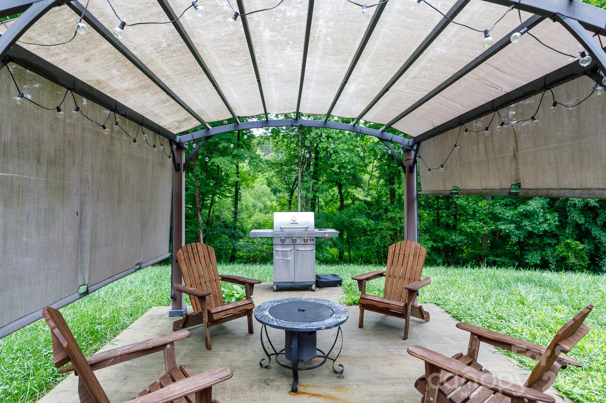 652 Sutton Spring Road York, SC 29745 - Photo 20 of 28 a view of a chair and fire pit in the patio next to a yard