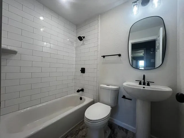 a bathroom with a sink toilet and shower