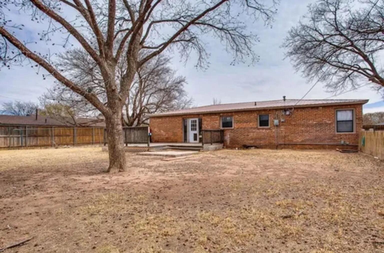 4906 60th Street Lubbock, TX 79414 - Photo 5 of 7 a front view of a house with a yard and garage